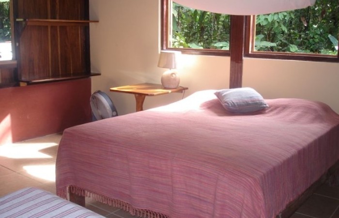 bedroom with a Queen and two single beds